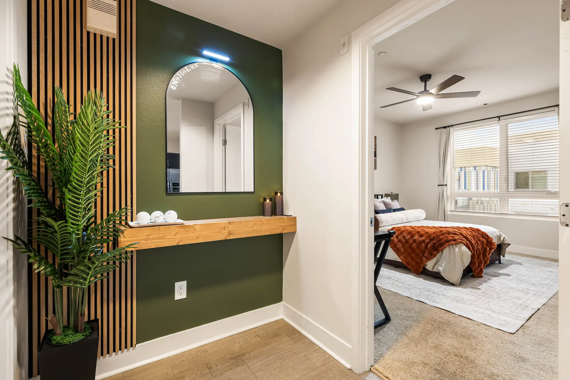 Entryway of The NoHo Lux Residence with styled mirror and greenery